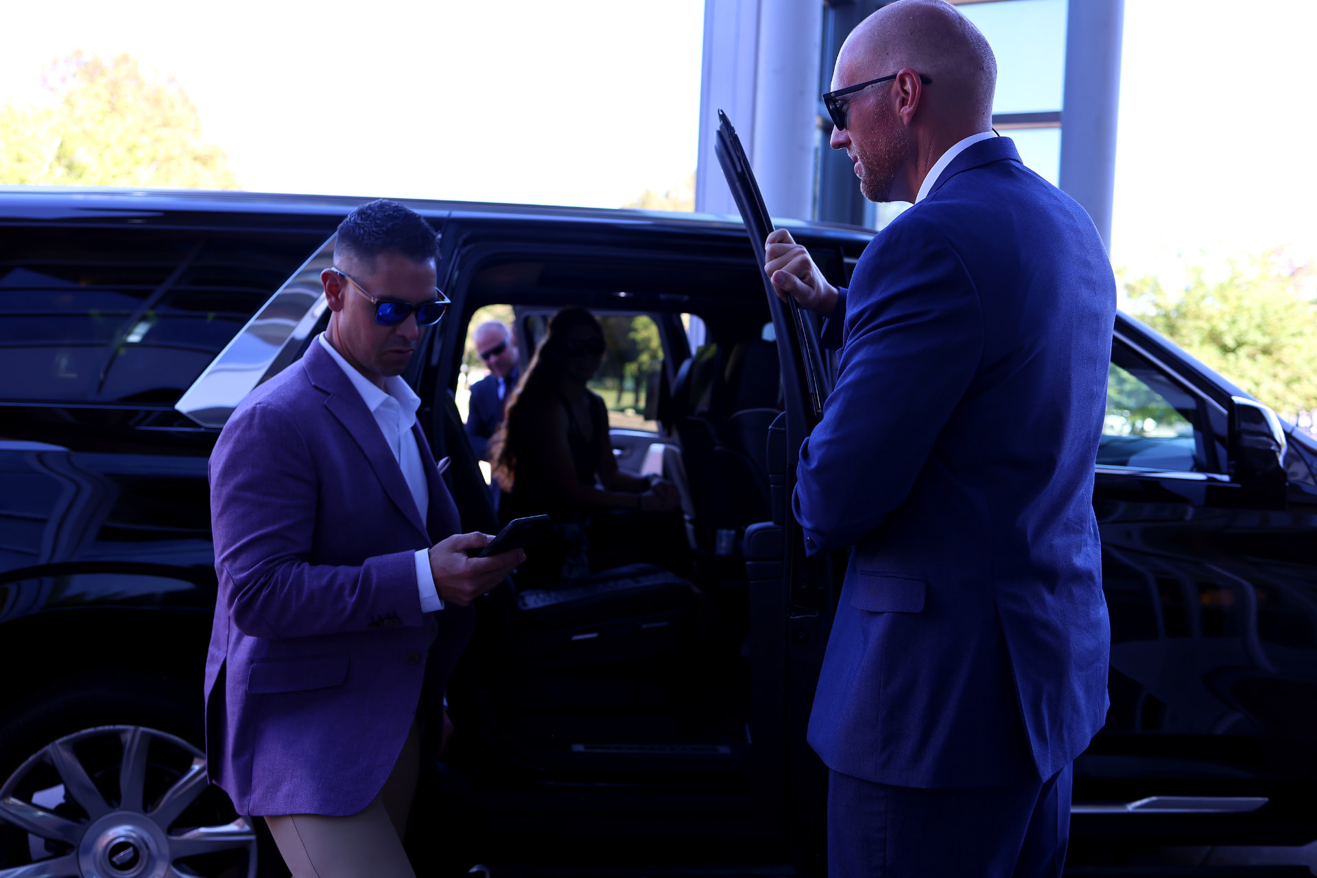 AMERINE personnel beside an executive vehicle during a passenger transition.